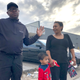 Rapper turned political candidate, Brad “Scarface” Jordan, left, visits with voter Michele Lemon and her son outside of an early voting location in the Sunnyside neighborhood of Houston, Texas.
